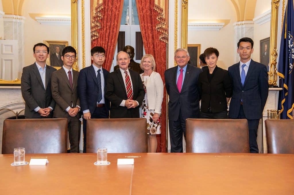 Senator James Risch (R-ID, Senate Foreign Relations Committee chairman, striped tie) and Senator Bob Menendez (D-NJ, ranking Democrat on the Committee, red tie), shown above meeting with Hong Kong activists prominent in the 2019-2020 freedom protests. Each of the two senators have sponsored recent reports on the need for working with allies to coordinate policies for dealing with China.